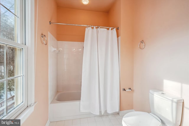 bathroom with shower / bathtub combination with curtain and toilet