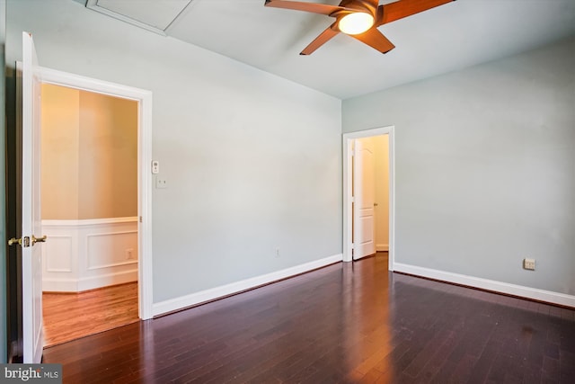 empty room featuring dark wood-type flooring and ceiling fan