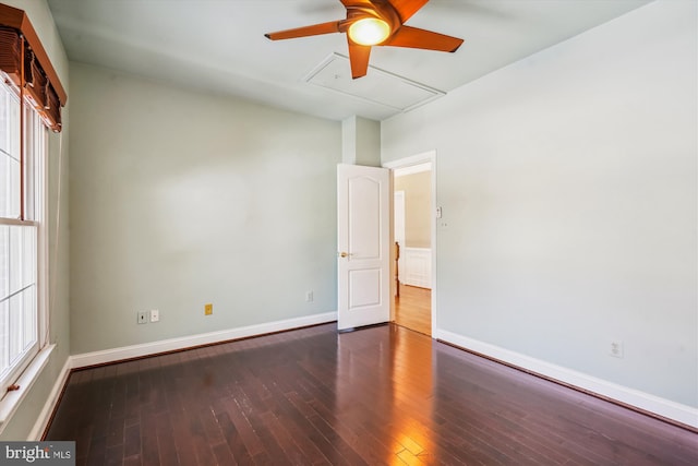 empty room featuring dark wood-type flooring and ceiling fan