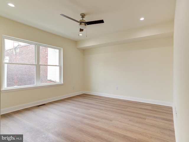 empty room featuring ceiling fan and light hardwood / wood-style flooring