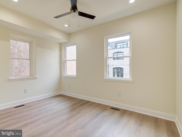 spare room featuring light hardwood / wood-style floors and ceiling fan