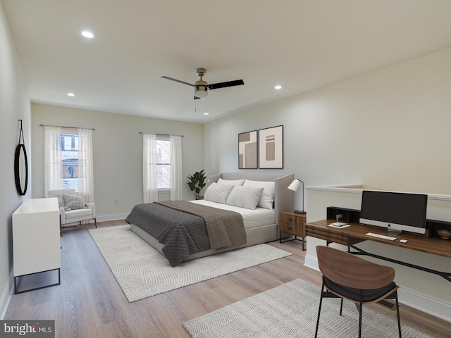 bedroom with ceiling fan and light wood-type flooring