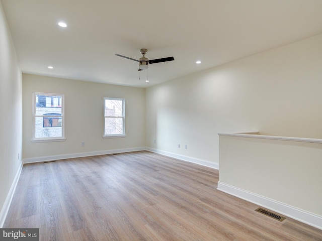 spare room featuring ceiling fan and light wood-type flooring