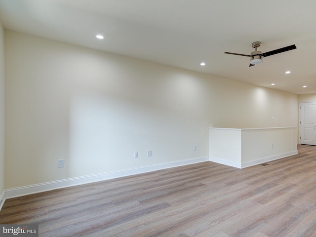 unfurnished room with light wood-type flooring and ceiling fan