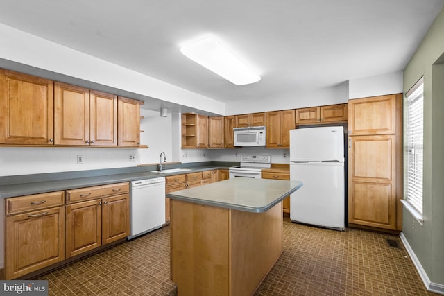 kitchen featuring sink, white appliances, and a kitchen island