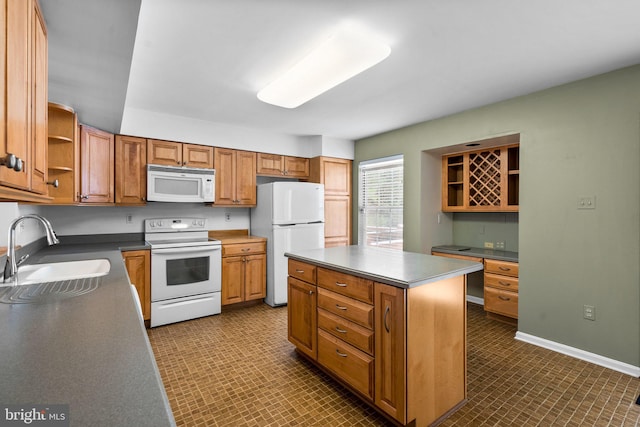 kitchen with sink, white appliances, and a kitchen island