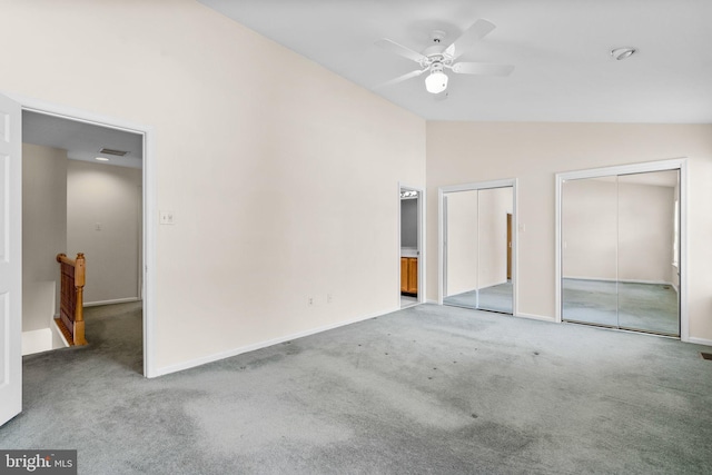 interior space featuring lofted ceiling, light carpet, and ceiling fan