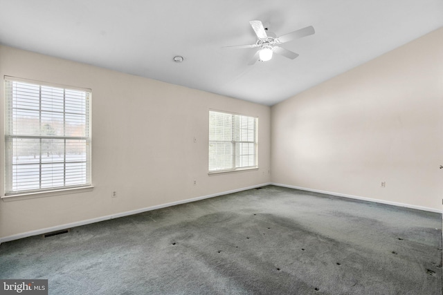 unfurnished room featuring ceiling fan, carpet, and lofted ceiling