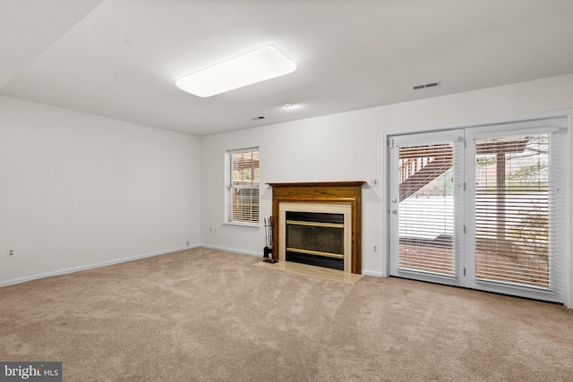 unfurnished living room featuring light carpet