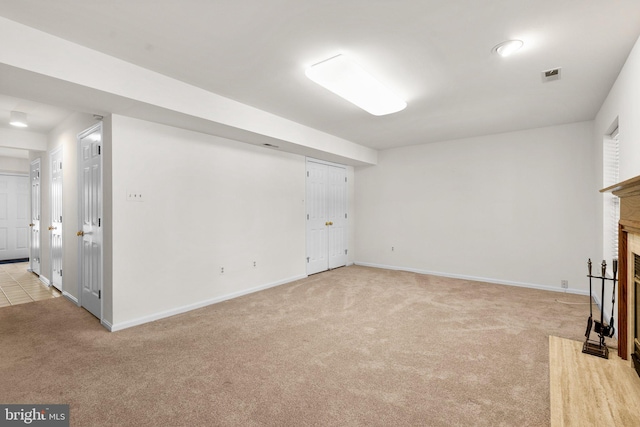 unfurnished living room featuring light colored carpet