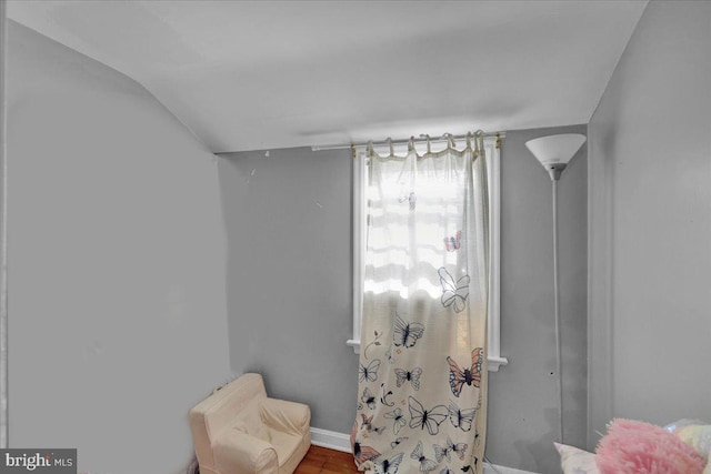 sitting room featuring hardwood / wood-style floors and vaulted ceiling