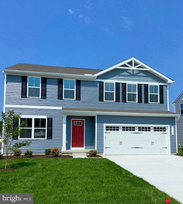 view of front of home featuring a front yard and a garage