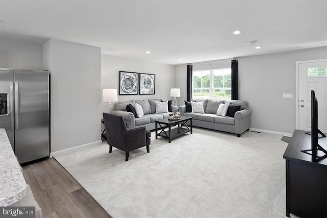 living room with plenty of natural light and hardwood / wood-style floors