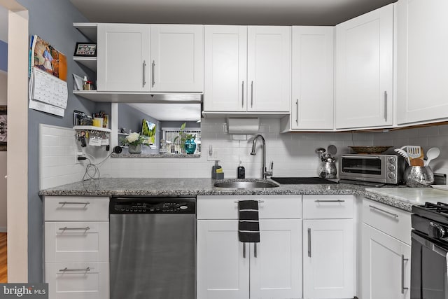 kitchen featuring backsplash, stone countertops, stainless steel dishwasher, white cabinets, and sink