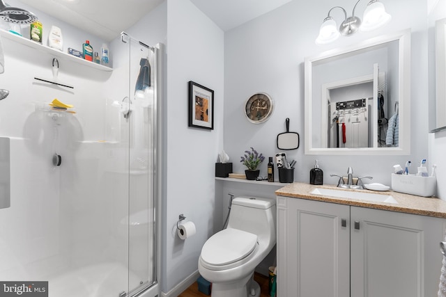 bathroom featuring vanity, toilet, and an enclosed shower