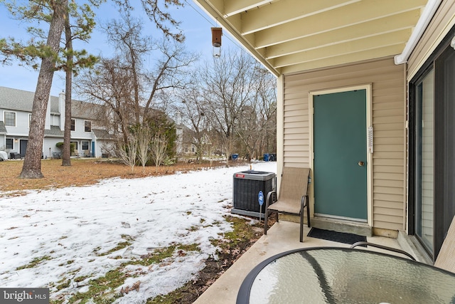 yard covered in snow with central AC