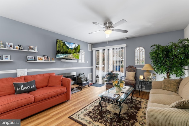 living room featuring ceiling fan and hardwood / wood-style flooring