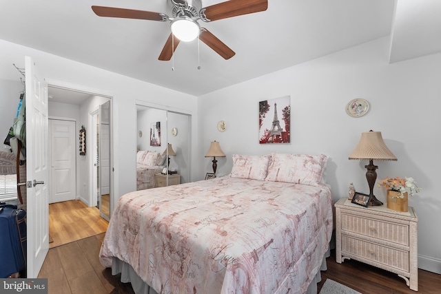 bedroom with ceiling fan, a closet, and dark hardwood / wood-style floors