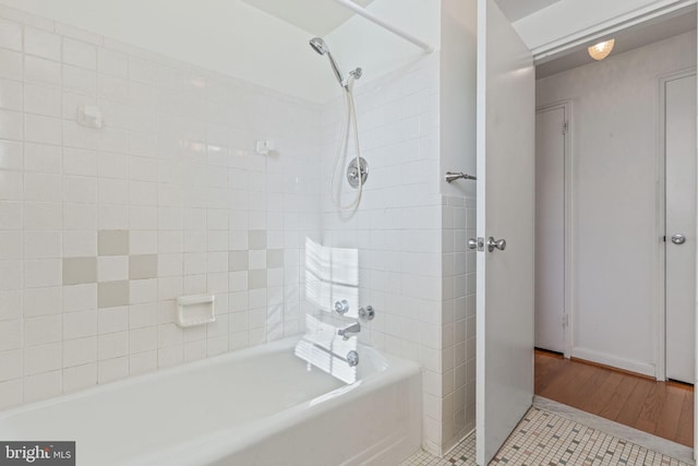 bathroom with tiled shower / bath combo and tile patterned floors