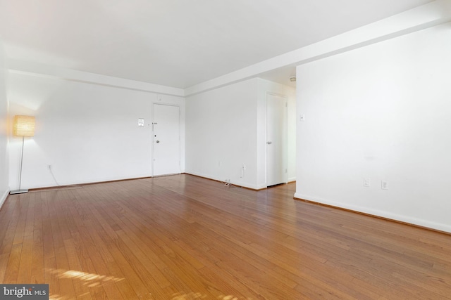 empty room with hardwood / wood-style floors