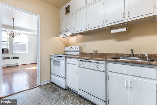 kitchen featuring white appliances, a chandelier, white cabinetry, radiator heating unit, and sink