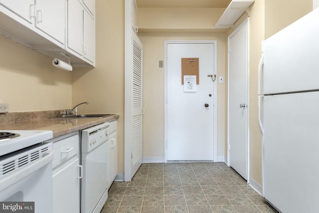 kitchen with sink, white appliances, and white cabinets