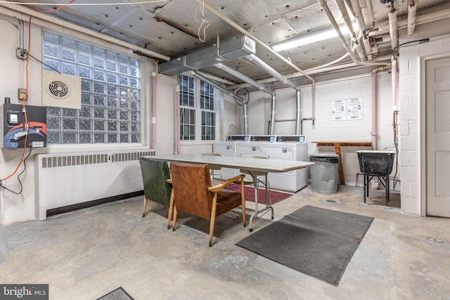 basement with washer and dryer and radiator