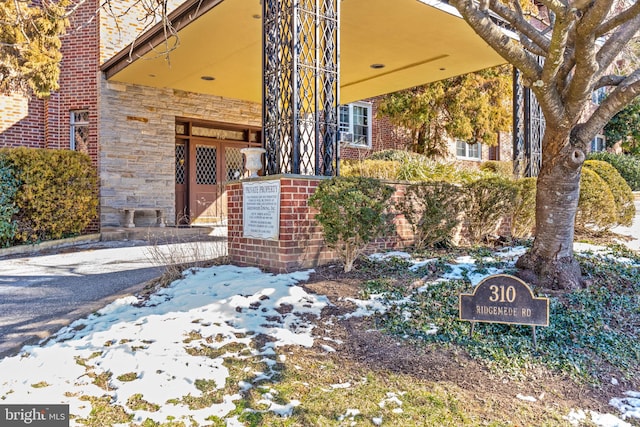 view of snow covered property entrance