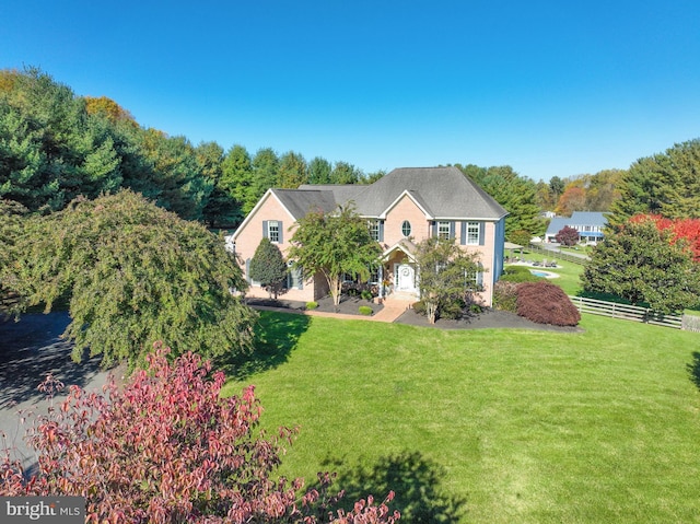 view of front of house featuring a front yard and fence