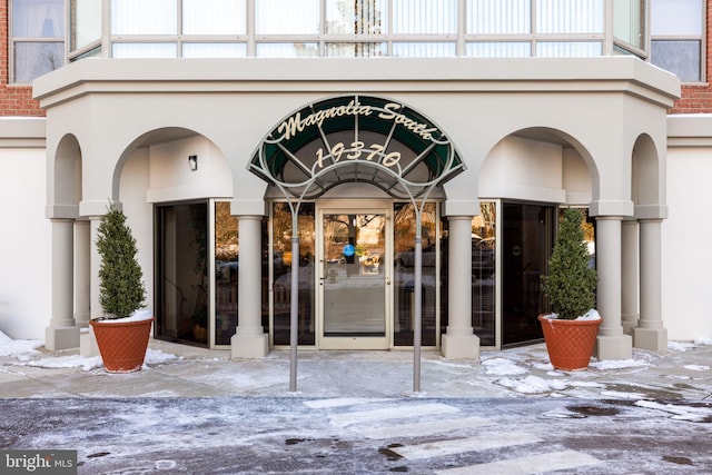 view of exterior entry with a balcony