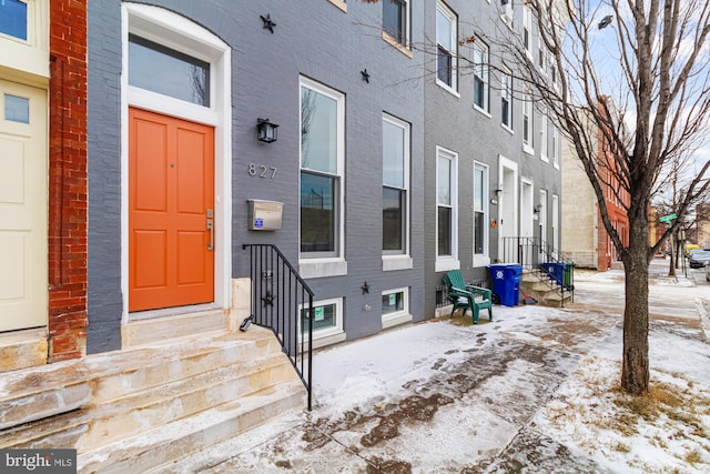 view of snow covered property entrance