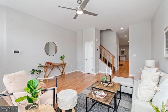 living room featuring ceiling fan and light wood-type flooring