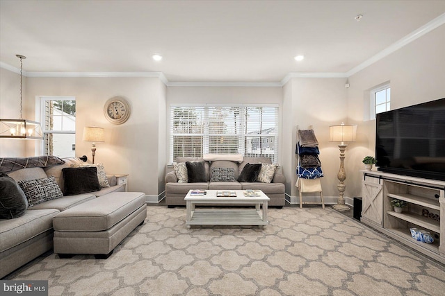 living room featuring an inviting chandelier, ornamental molding, and a healthy amount of sunlight