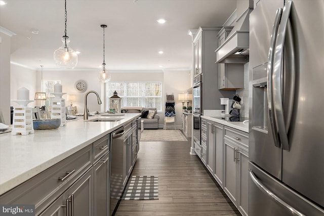 kitchen with dark hardwood / wood-style flooring, decorative light fixtures, sink, gray cabinetry, and stainless steel appliances