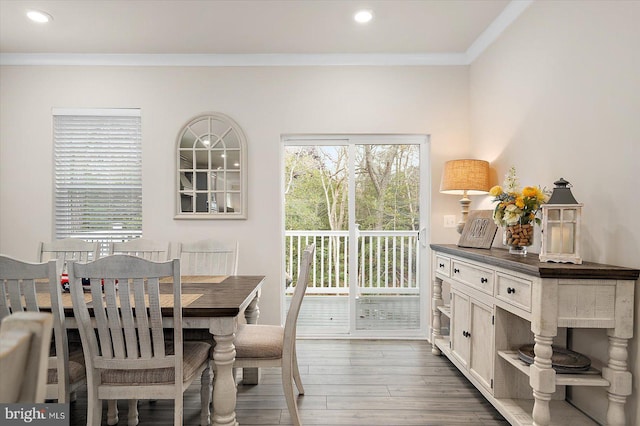 dining area featuring dark hardwood / wood-style flooring and crown molding