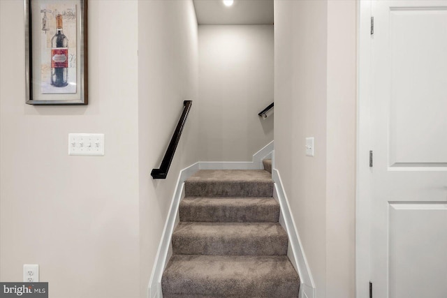 stairs featuring carpet flooring