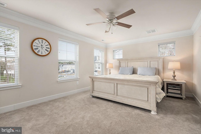 carpeted bedroom with ceiling fan, multiple windows, and crown molding