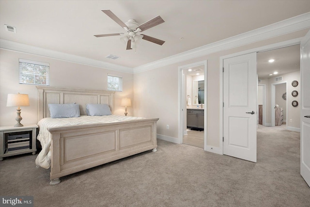 carpeted bedroom featuring ceiling fan, ensuite bathroom, and ornamental molding