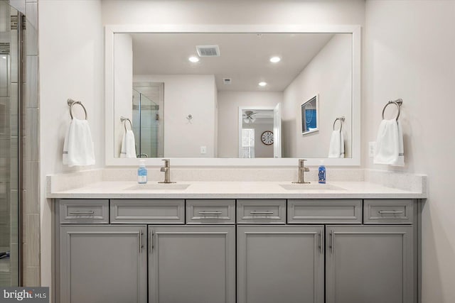 bathroom featuring an enclosed shower and vanity