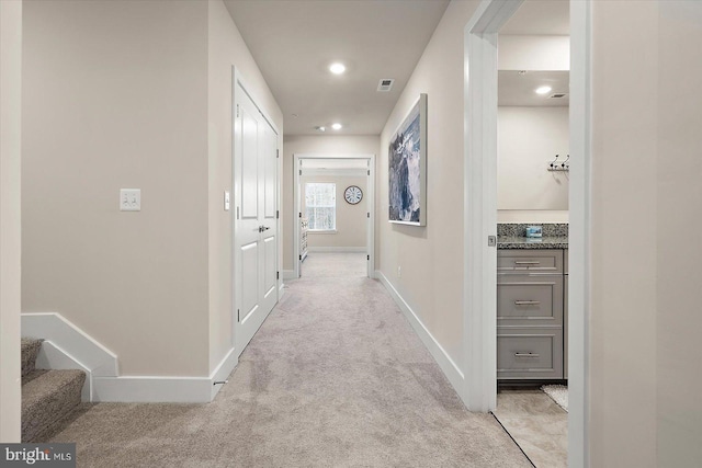 corridor with light colored carpet