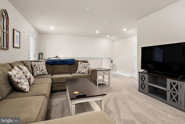 carpeted living room featuring vaulted ceiling