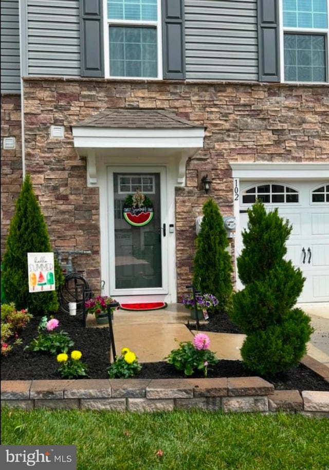 view of exterior entry featuring a garage