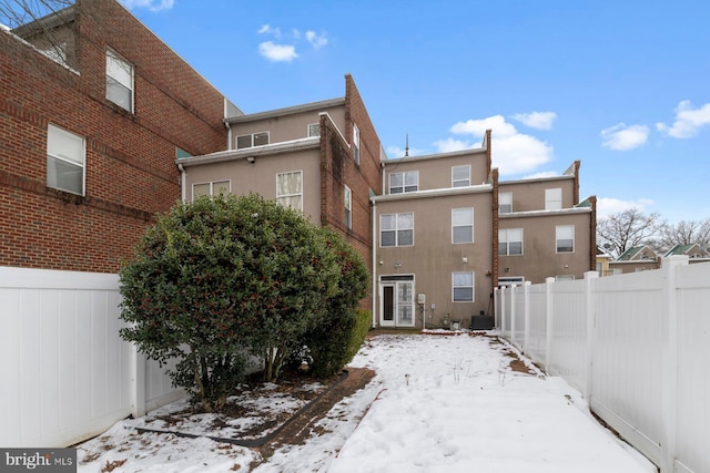 view of snow covered exterior featuring central AC