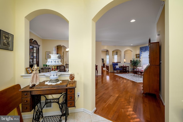 interior space with light wood-type flooring and ornamental molding