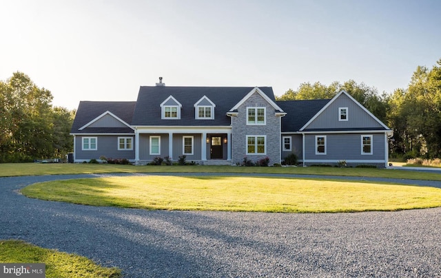 cape cod-style house with a front yard