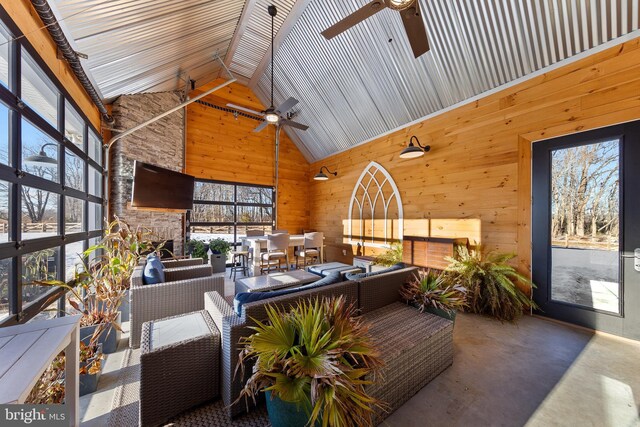 sunroom with ceiling fan and vaulted ceiling