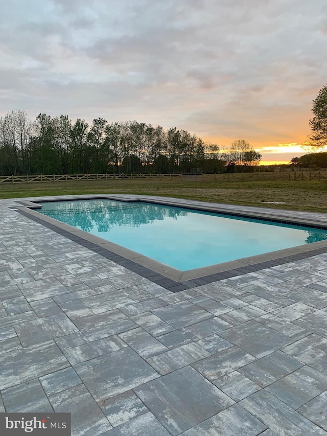 view of pool at dusk