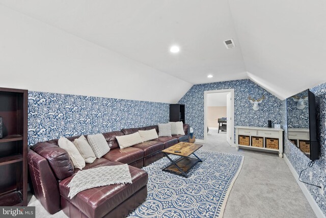 living room featuring lofted ceiling and light carpet