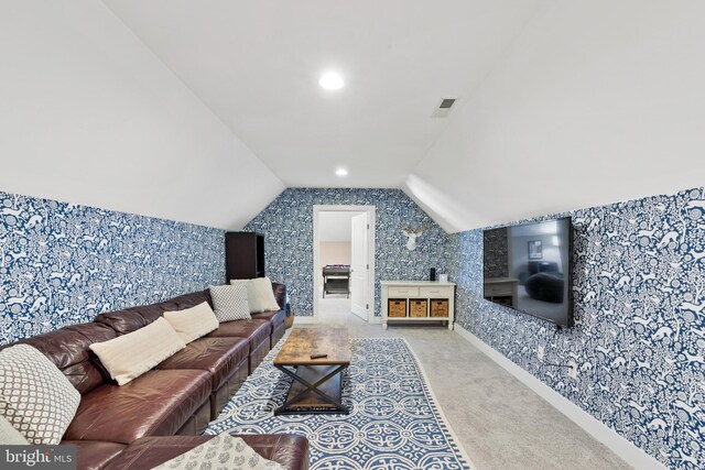 living room with lofted ceiling and carpet flooring