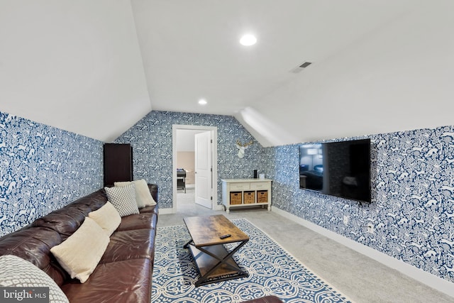 carpeted living room featuring vaulted ceiling